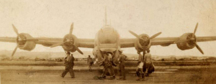 Head-on view of PB4Y-2 Privateer with airmen walking in front